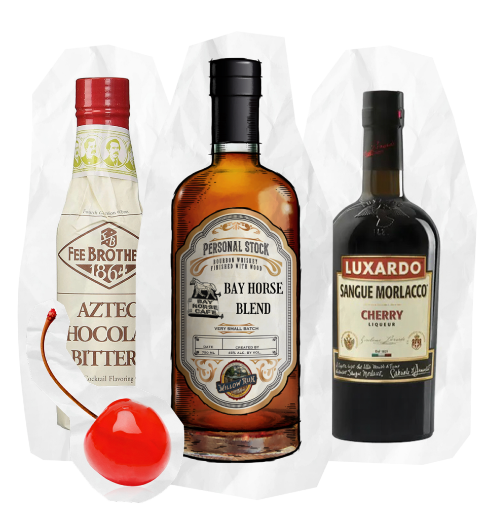 Three bottles are displayed: Fee Brothers Aztec Chocolate Bitters, Willow Run Custom Bourbon from Bay Horse Cafe, and Luxardo Sangue Morlacco Cherry Liqueur. A bright red maraschino cherry rests in front on a white background.