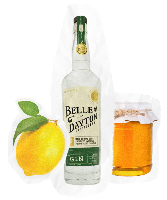 A bottle of Belle of Dayton Gin from Belle of Dayton Distillery, a whole lemon with leaves, and a jar of honey with a paper cover and twine—all thoughtfully arranged on a white background—capture the essence of Crafted & Cured sophistication.