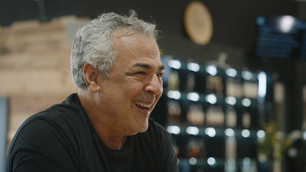 A middle-aged man with grey hair laughing at Noble Cut Distillery.
