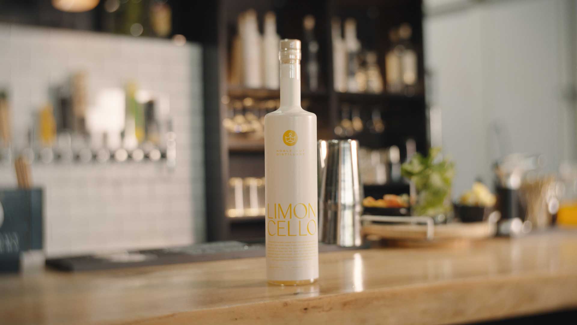 A bottle of Noble Cut Distillery Limoncello from Z Cucina di Spirito standing on a bar counter.
